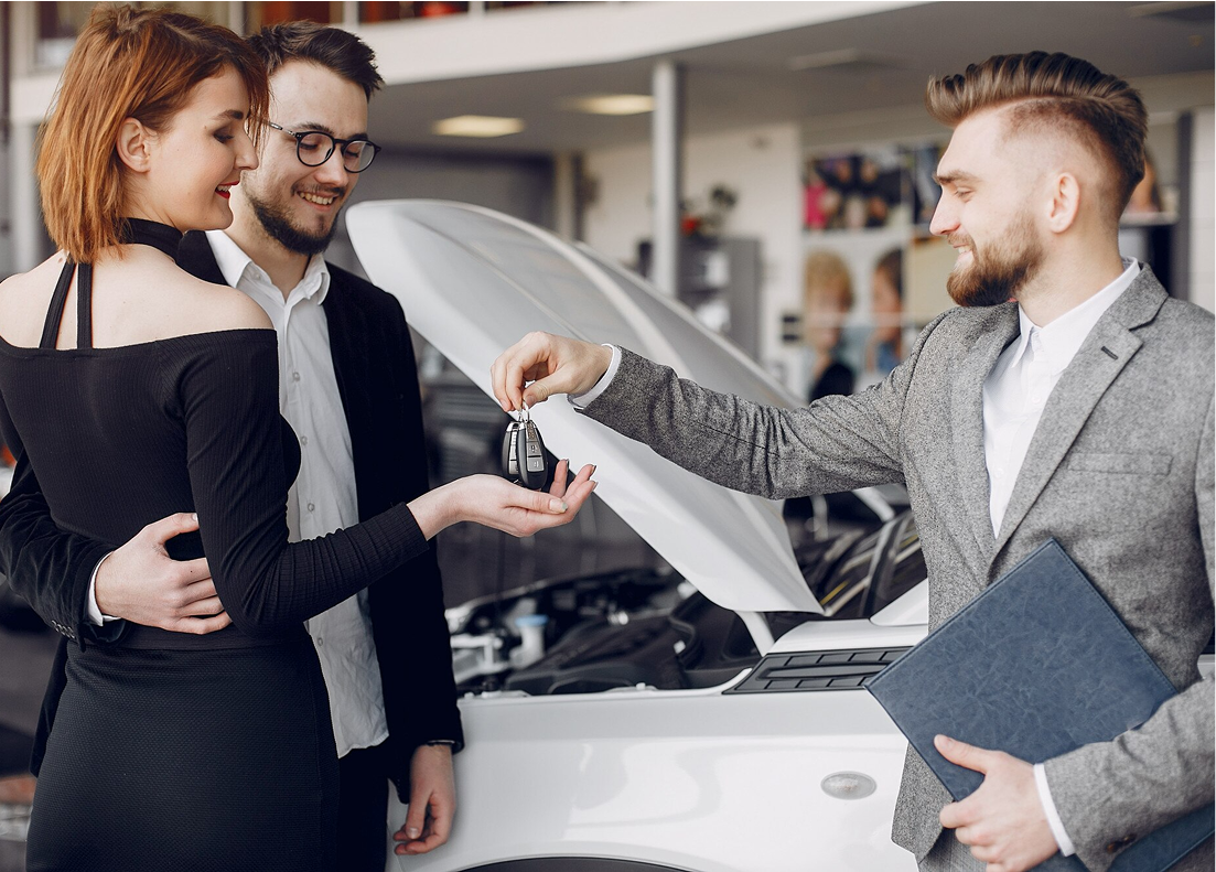 Stylish and elegant couple in a car salon